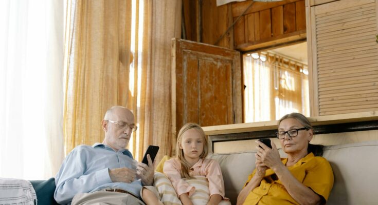 Man in Blue Dress Shirt Sitting Beside Girl in Yellow Tank Top